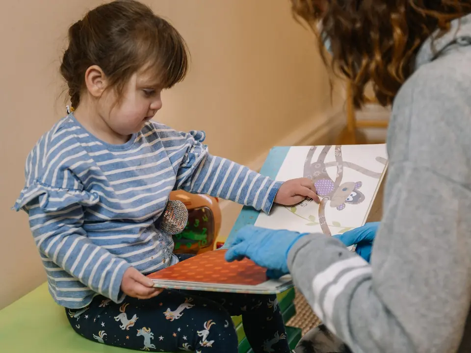 A child enjoying a reading activity at Naomi’s Garden